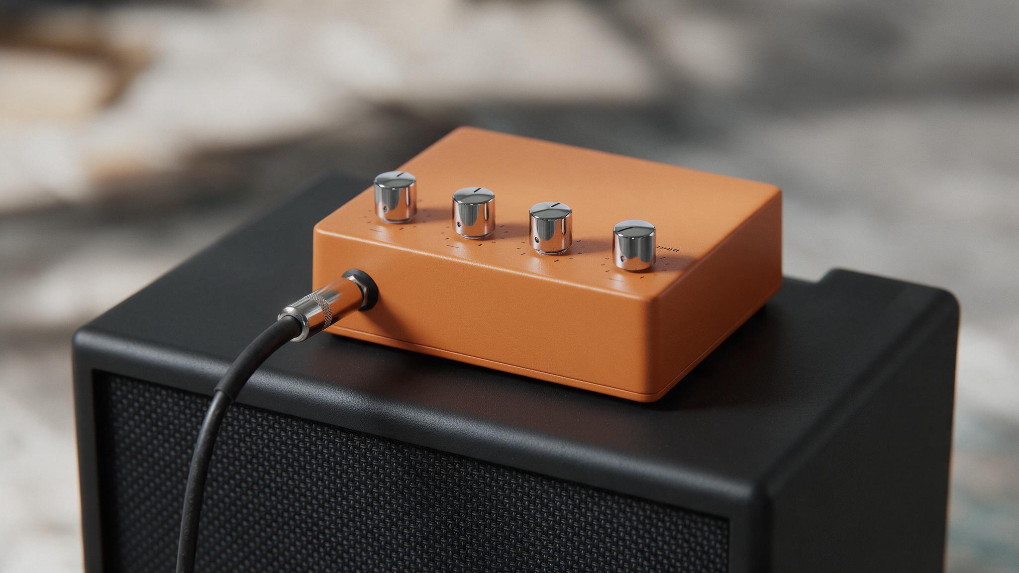 Tête d'ampli basse orange compacte posée sur un baffle 1x12 noir